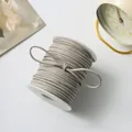 Grey double-sided faux suede cord on a white spool for DIY handicrafts - 50 Yards / Light Gray