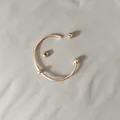 Close-up view of a rose gold titanium steel bangle featuring a screw-off ball end. - Unscrewed Ball Head DIY Open Bangle (YB-1089RG) / Inner Diameter 60mm (With 2 Positioning Beads) / Rose Gold