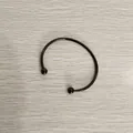 Top view of a black stainless steel open cuff bracelet with ball ends on wood background - Unscrewed Ball Head DIY Open Bangle (YB-219BLK) / Inner Diameter 70mm (Without Positioning Beads) / Black