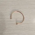 Macro view of a polished rose gold stainless steel open bangle with decorative ball ends. - Unscrewed Ball Head DIY Open Bangle (YB-219RG) / Inner Diameter 60mm / Rose Gold