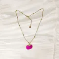 Detailed close-up of a vibrant hot pink seashell pendant on a gold beaded chain necklace. - Gold Pink Scallop Style (YN-1053-M)