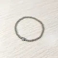 Close-up view of silver stainless steel beaded elastic bracelet with heart letter C charm - Heart Initial C Style (YB-S1090-C) / Stretchy