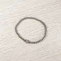 Detail view of a silver stainless steel beaded bracelet with a heart initial 'E' charm. - Heart Initial E Style (YB-S1090-E) / Stretchy