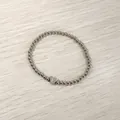 Detailed view of a silver stainless steel bead bracelet with an engraved heart 'F' charm - Heart Initial F Style (YB-S1090-F) / Stretchy