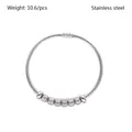 Macro detail of a silver stainless steel spring coil bracelet with textured beads. - 6 Knurled Craft Beads Style (YB-029) / Silver