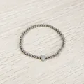 Macro view of a silver stainless steel beaded bracelet with heart charm and letter J - Heart Initial J Style (YB-S1090-J) / Stretchy