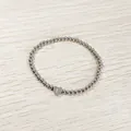 Detailed view of a silver stainless steel beaded elastic bracelet with a heart initial L charm - Heart Initial L Style (YB-S1090-L) / Stretchy