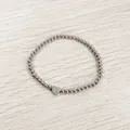 Detail view of silver stainless steel beaded bracelet with engraved heart P charm - Heart Initial P Style (YB-S1090-P) / Stretchy