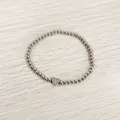 Detailed view of silver stainless steel beaded bracelet with an engraved heart charm - Heart Initial T Style (YB-S1090-T) / Stretchy