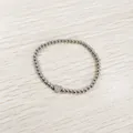 Close-up of heart-shaped 'U' charm on silver stainless steel bead bracelet - Heart Initial U Style (YB-S1090-U) / Stretchy