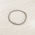 Detailed macro view of the heart charm engraved with letter W on a silver beaded bracelet - Heart Initial W Style (YB-S1090-W) / Stretchy