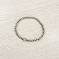 Detail macro view of a silver stainless steel beaded bracelet with an engraved heart initial X charm - Heart Initial X Style (YB-S1090-X) / Stretchy