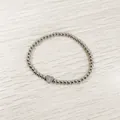 Macro view of a silver stainless steel bead bracelet with a heart 'Y' initial charm. - Heart Initial Y Style (YB-S1090-Y) / Stretchy