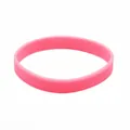 Detail view of a solid pink luminous silicone wristband with a flexible rubber texture - Pink