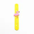 Detailed view of yellow flamingo slap bracelet with colorful star patterns. - Yellow