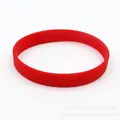 Close-up detail of a vibrant red luminous silicone wristband for sports and events - Red