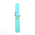 Detailed view of light blue silicone slap bracelet with flamingo and star patterns - Teal