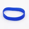 Detailed view of a flexible blue silicone wristband on a plain white background. - Sapphire Blue