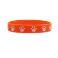 Vibrant orange silicone wristband featuring cute white cat paw prints for animal lovers - Orange