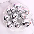 Macro view of silver mirror disco balls in various sizes for party cake decoration - Set of 12 / Silver