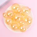 Close-up view of shimmering iridescent golden sphere cake toppers in various sizes - Set of 12 / Gold