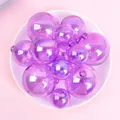 Close-up of iridescent purple decorative spheres in various sizes on a white plate. - Set of 12 / Purple