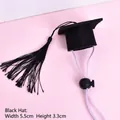 Close-up view of a black pet graduation cap featuring dimensions and an adjustable strap. - Black Tassel