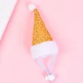 Close-up of a gold sequin pet Santa hat featuring white plush trim and an adjustable strap. - Gold