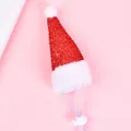 Close-up of glittery red pet Christmas hat with adjustable white elastic strap - Red