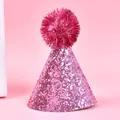 Detail view of a sparkly pink glitter party hat for pets with a shiny tinsel pom-pom. - Thick Glitter Pompom / Pink