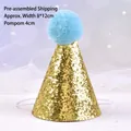 Close-up detail of a gold glitter pet birthday hat with a fluffy light blue pom-pom. - Birthday Hat / Gold
