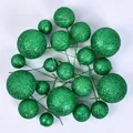 Close-up of green glitter cake topper balls in various sizes for dessert decoration - 20 Pieces Set / Glitter Green
