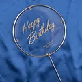 Detailed view of round gold metal cake topper with Happy Birthday engraving - Round Transparent