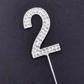 Close-up of a sparkling silver rhinestone number 2 cake topper for birthday decor - Number 2 / Silver