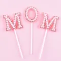 Detail view of pink pearl and rhinestone MOM cake toppers for Mother's Day decorations - Pearl MOM Style / Pink