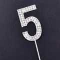 Close-up detail of silver rhinestone cake topper number 5 with sparkling clear gems - Number 5 / Silver