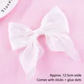 Detail of a white mesh bow cake topper, width 12.5cm with sticks and glue dots included. - Mesh Bow-knot (022) / White