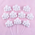 Detailed view of ten white fluffy pom-pom cloud cake toppers on a pink backdrop. - Round Cloud Shape / 10 Pieces Pack