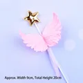 Close-up of pink feather wing cake topper with a gold star and elegant ribbon details. - Pink Plastic Wings / Pink