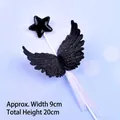 Close-up of black star and plastic wings cake topper decoration with 20cm height scale - Black Plastic Wings / Black