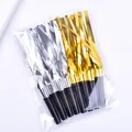 Close-up detail of gold and silver party blowouts whistles for birthday celebration - 4 Gold 4 Silver