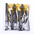 Detail of golden and silver party blowout whistles in transparent plastic packaging - 11cm 3 Gold 3 Silver