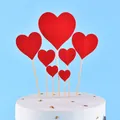 Detailed view of multiple red heart cake toppers in various sizes on a white cake - Heart / 7-Pack Set / Red