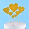 Seven golden glittery heart-shaped cake toppers arranged on a elegant white dessert cake - Heart / 7-Pack Set / Gold