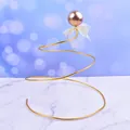 Elegant gold spiral iron wire cake topper with metallic ball and mesh bow detail. - Spiral Sphere / Gold