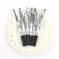 Silver foil party blowers with black mouthpieces arranged on a decorative daisy plate. - Silver 6 Pieces