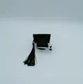 Close-up detail of a miniature black graduation cap hair clip with tassel - Mini Graduation Cap Hair Clip (LM-4789) / Black