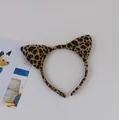 Macro view of a leopard print plush cat ear headband for costume parties and fun dress-up - Leopard Print