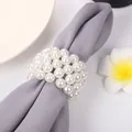 Detailed macro view of an elegant woven pearl napkin ring on a grey cloth napkin. - Woven Pearl Style (C226) / White