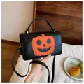 Stylish black Halloween pumpkin crossbody handbag for women with orange patchwork design - Black